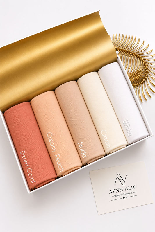 Aynn Alif plain jersey hijabs in Desert Coral, Creamy Peach, Nude, Cream and White displayed together.