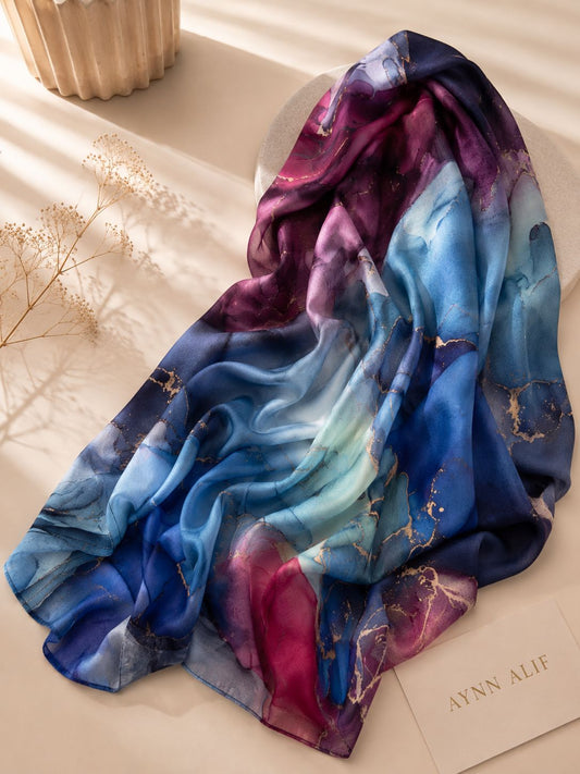 Aynn Alif extra large modal lawn hijab featuring a blue marble print with ruby red tones and elegant gold accents in a soft breathable fabric.