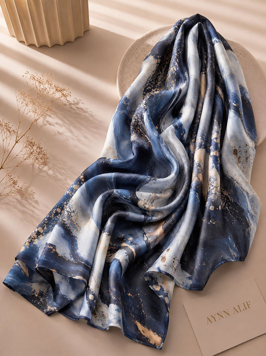 Blue marble printed modal lawn hijab in navy blue, ivory and gold abstract pattern, extra-large breathable scarf with soft flowing drape.
