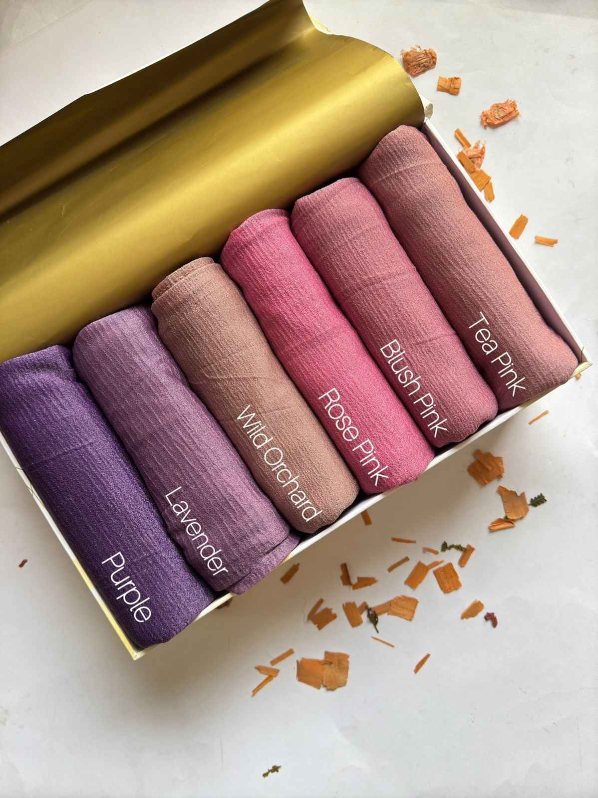 Crimped Moonlight Jersey Hijab Collection by Aynn Alif Pakistan featuring Purple, Lavender, Wild Orchid, Rose Pink, Blush Pink, and Tea Pink shades in soft, breathable, lightweight textured jersey fabric.