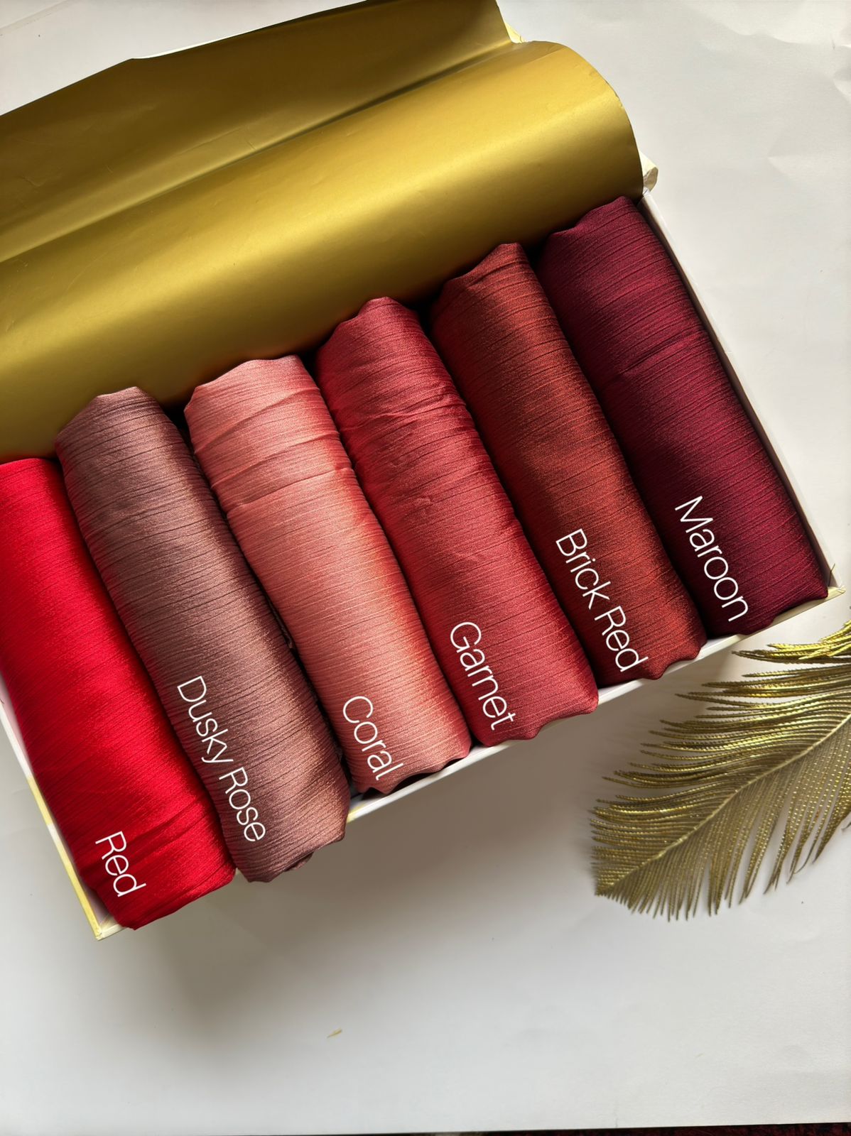 Crinkle Silk Hijab Ruby Rose Collection featuring Red, Dusky Rose, Coral Pink, Garnet, Brick Red and Maroon shades in premium textured silk fabric.