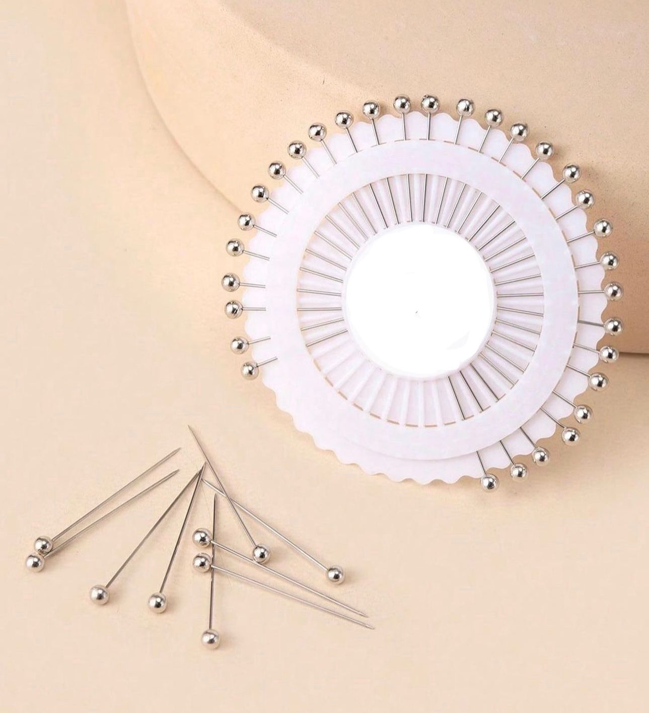Silver pinwheel hijab pins featuring 30 metallic silver scarf pins for elegant hijab styling.