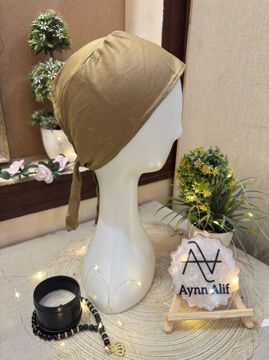 Light brown plain hijab cap displayed on mannequin