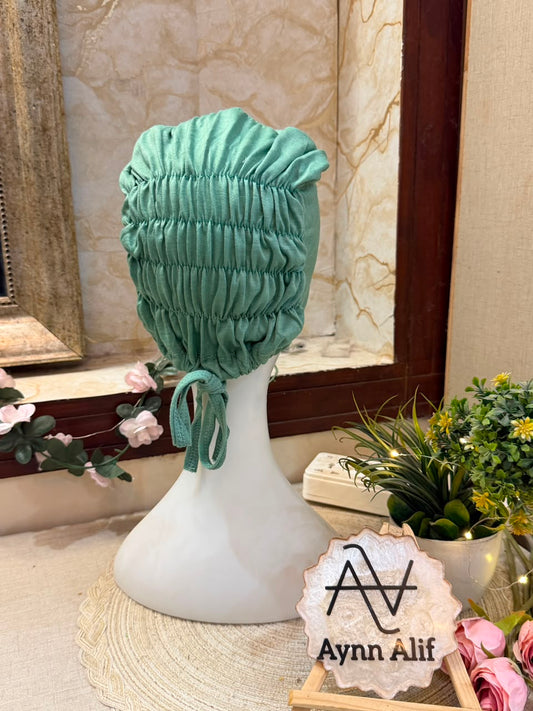 Mint Green ruched tie back hijab cap made from soft breathable jersey with full head coverage and adjustable tie-back by Aynn Alif.