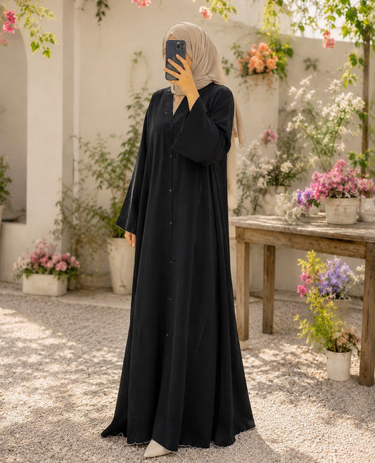 Black button-down Nidah abaya with one-side stone embellishments, embellished sleeves and matching scarf by Aynn Alif Pakistan.