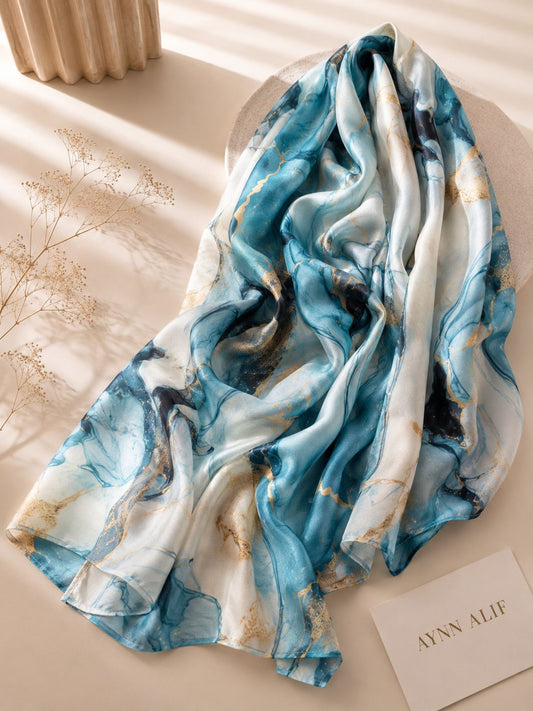 Aynn Alif Ocean Marble printed modal lawn hijab in sky blue, ivory white and gold abstract marble pattern, extra-large breathable scarf.