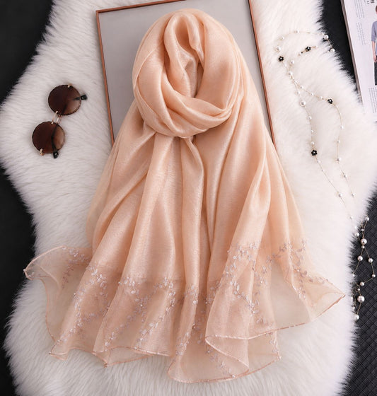 Peach cotton silk hijab with embroidered organza border and soft drape.