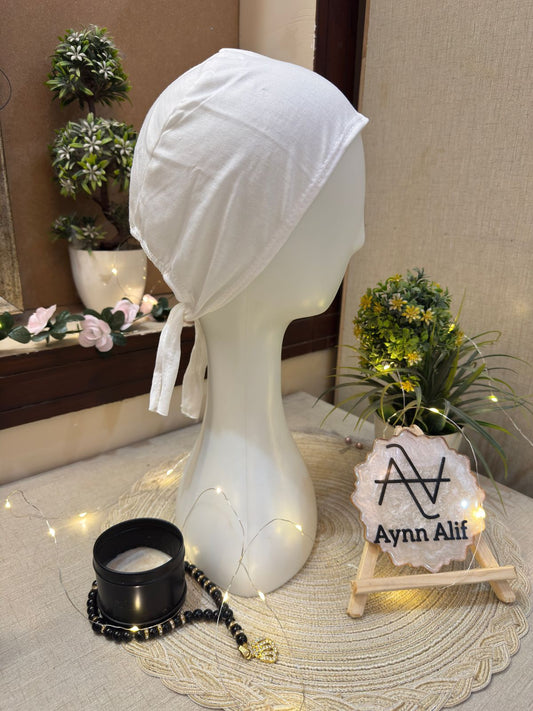 White tie-back hijab cap in soft fabric on mannequin