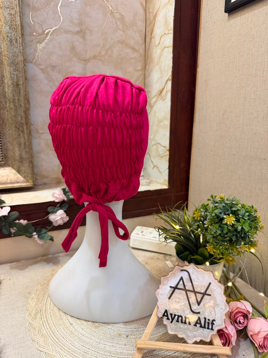 Shocking Pink ruched tie back hijab cap made from soft breathable jersey with full head coverage and adjustable tie-back by Aynn Alif.
