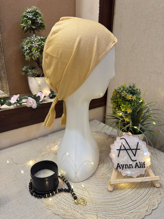 Skin plain tie-back hijab underscarf cap displayed on mannequin