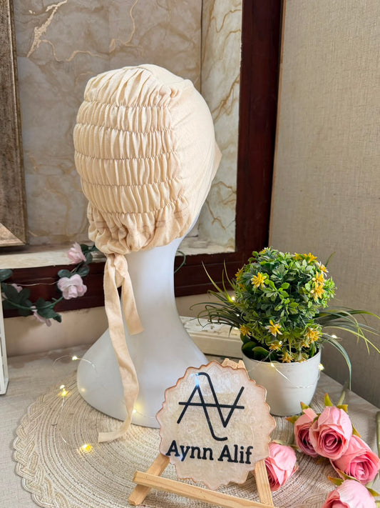 Vanilla ruched tie back hijab cap made from soft breathable jersey with full head coverage and adjustable tie-back by Aynn Alif.