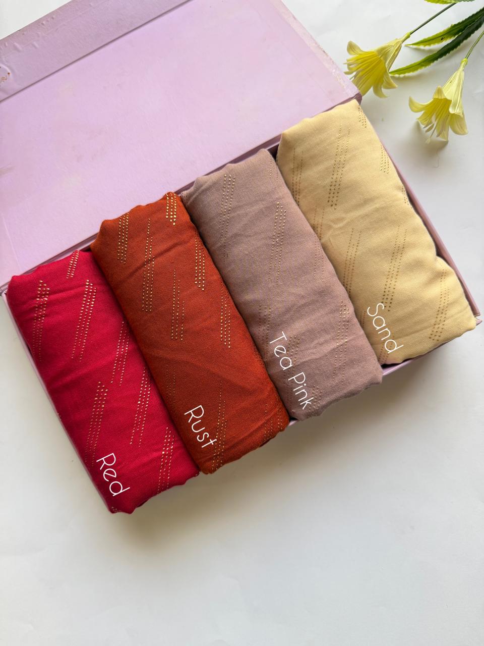 Warm tone lawn hijabs set in red, rust, tea pink and sand with golden embossed dot design in elegant box