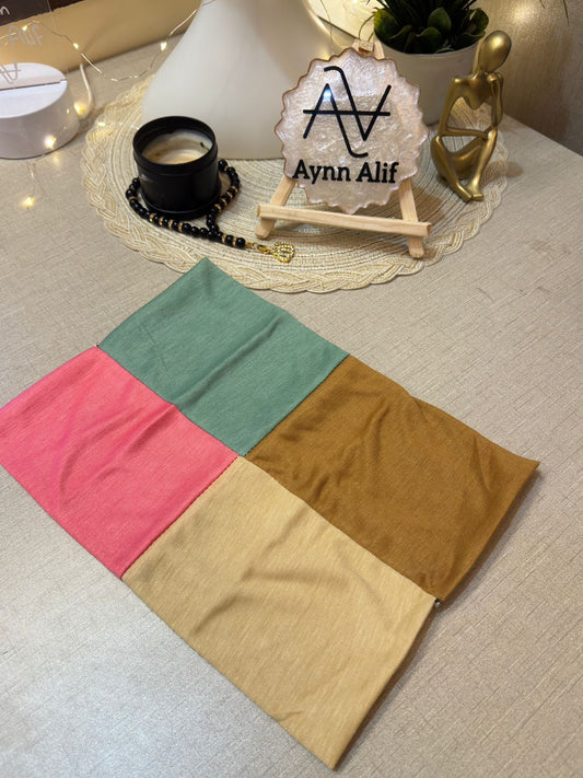 4 in 1 jersey tube band in Coral Pink, Mint Green, Skin and Topaz by Aynn Alif Pakistan – soft stretchable hijab undercap for secure and polished scarf styling.