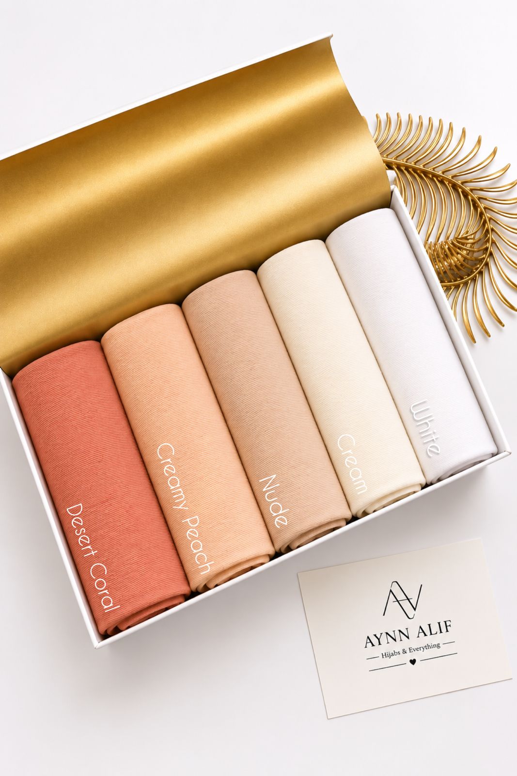 Aynn Alif plain jersey hijabs in Desert Coral, Creamy Peach, Nude, Cream and White displayed together.