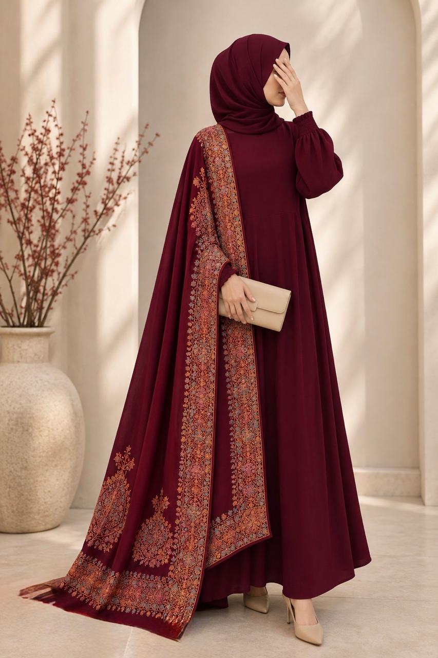 Berry red pashmina shawl featuring a multicoloured block-printed border on all four sides with intricate hand embroidery, styled over a matching outfit by AYNN ALIF
