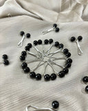 Black pearl loop pin for hijab styling featuring glossy black beads and silver glider design, snag-free scarf accessory with secure hold.