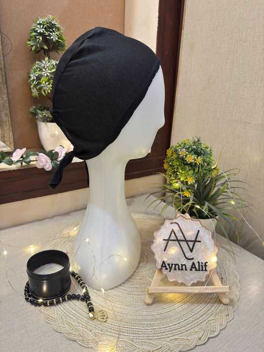 Black plain tie-back hijab cap on white mannequin side profile