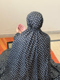 Black and white floral namaz chaadar for women by Aynn Alif Pakistan with elastic sleeves, elastic headband, wudu-friendly design, and full coverage prayer wear.