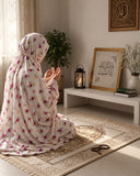 Aynn Alif blush ivory namaz chaadar featuring delicate pink, magenta and yellow floral prints, styled for prayer on a patterned prayer mat.