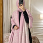 Blush pink and ivory paisley reversible woolen wrap styled over a black modest outfit