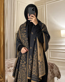 Charcoal black and camel paisley reversible woolen wrap styled over a black modest outfit