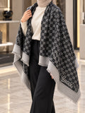 Charcoal black and grey monogram-inspired pashmina wrap with light grey border and fringed edges styled for elegant winter layering.