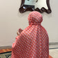 Coral pink namaz chaadar with white rings by Aynn Alif Pakistan featuring elastic sleeves, elastic headband, wudu-friendly design, breathable fabric, and full coverage prayer wear for women.