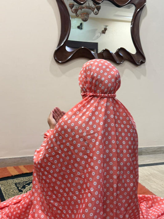 Coral pink namaz chaadar with white rings by Aynn Alif Pakistan featuring elastic sleeves, elastic headband, wudu-friendly design, breathable fabric, and full coverage prayer wear for women.