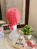 Coral Pink ruched tie back hijab cap made from soft breathable jersey with full head coverage and adjustable tie-back by Aynn Alif.