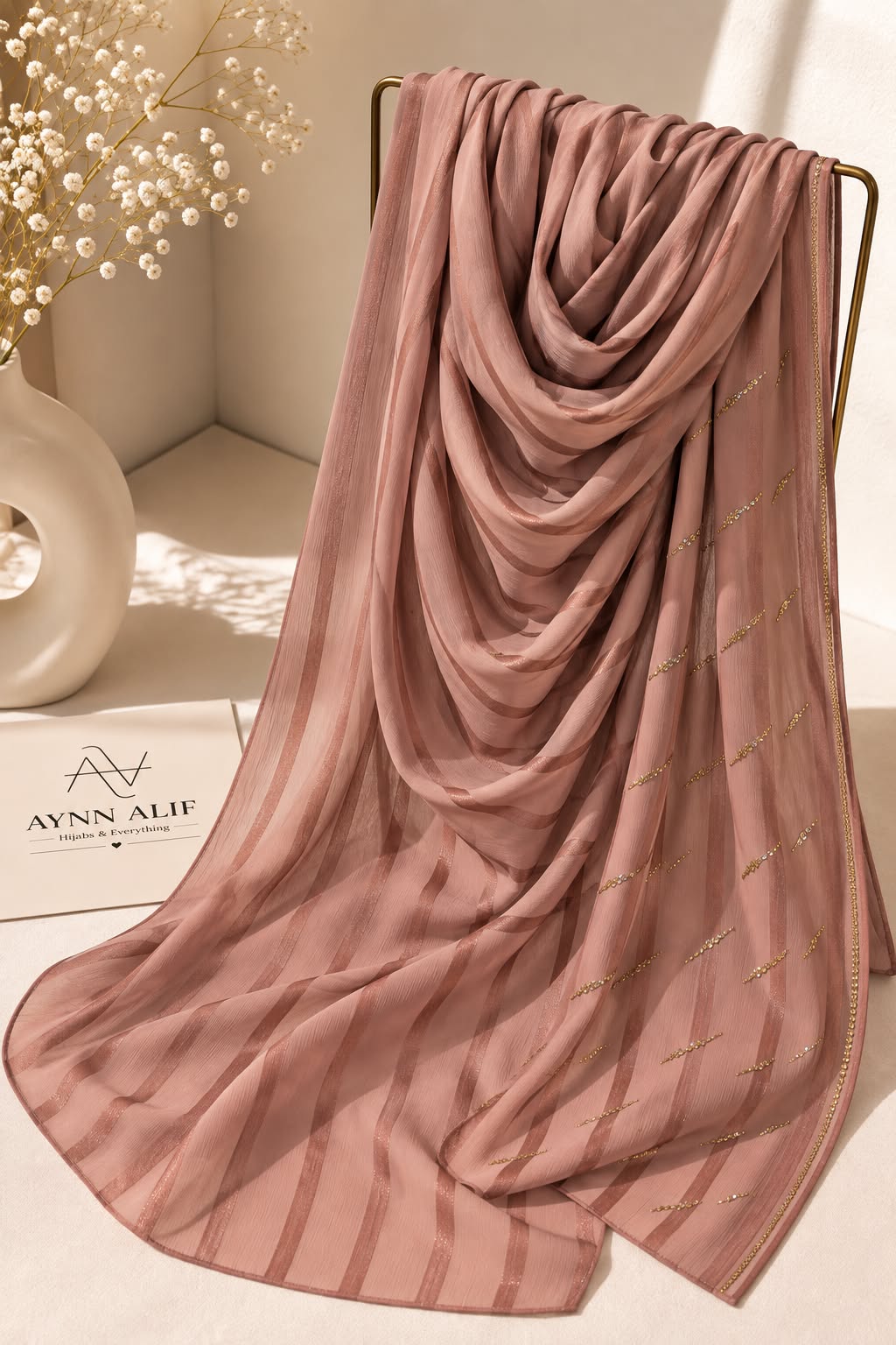 Coral pink crinkle chiffon georgette hijab with satin stripes and delicate stone-studded detailing by Aynn Alif.