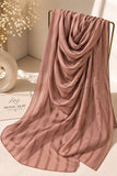 Coral pink crinkle chiffon georgette hijab with satin stripes and delicate stone-studded detailing by Aynn Alif.