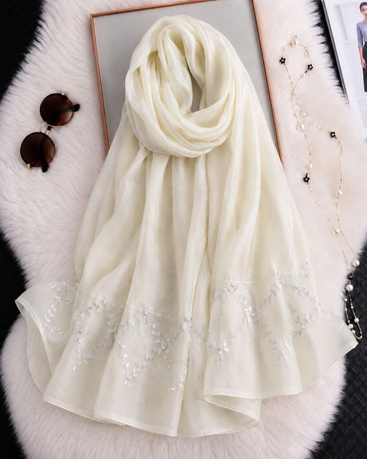 Cream cotton silk hijab with embroidered organza border and elegant detailing.