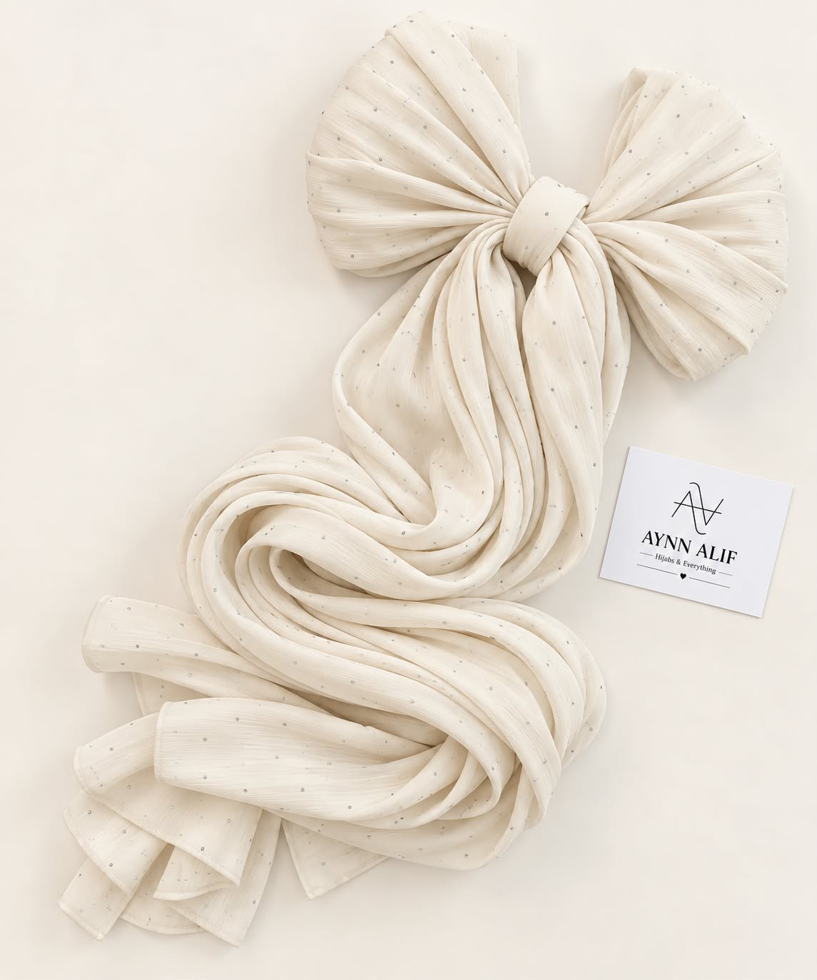 Cream stones-studded matte silk hijab with a soft flowy drape and delicate stone embellishments by Aynn Alif.