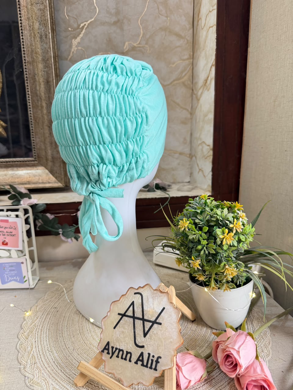 Cyan ruched tie back hijab cap made from soft breathable jersey with full head coverage and adjustable tie-back by Aynn Alif.