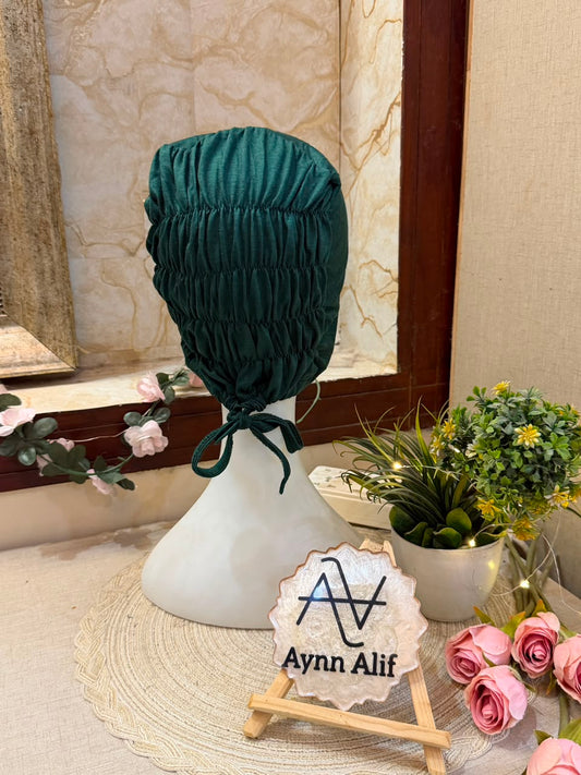 Dark Green ruched tie back hijab cap made from soft breathable jersey with full head coverage and adjustable tie-back by Aynn Alif.