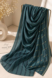 Dark green crinkle chiffon georgette hijab with satin stripes and delicate stone-studded detailing by Aynn Alif.