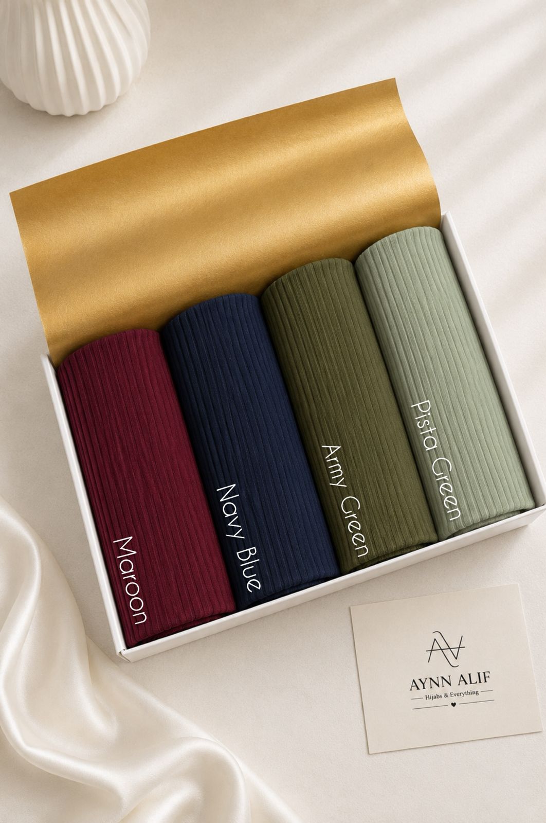 Aynn Alif large ribbed jersey hijabs in Maroon, Navy Blue, Army Green and Pista Green arranged in a white presentation box.