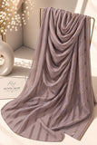 Dusty mauve crinkle chiffon georgette hijab with satin stripes and delicate stone-studded detailing by Aynn Alif.
