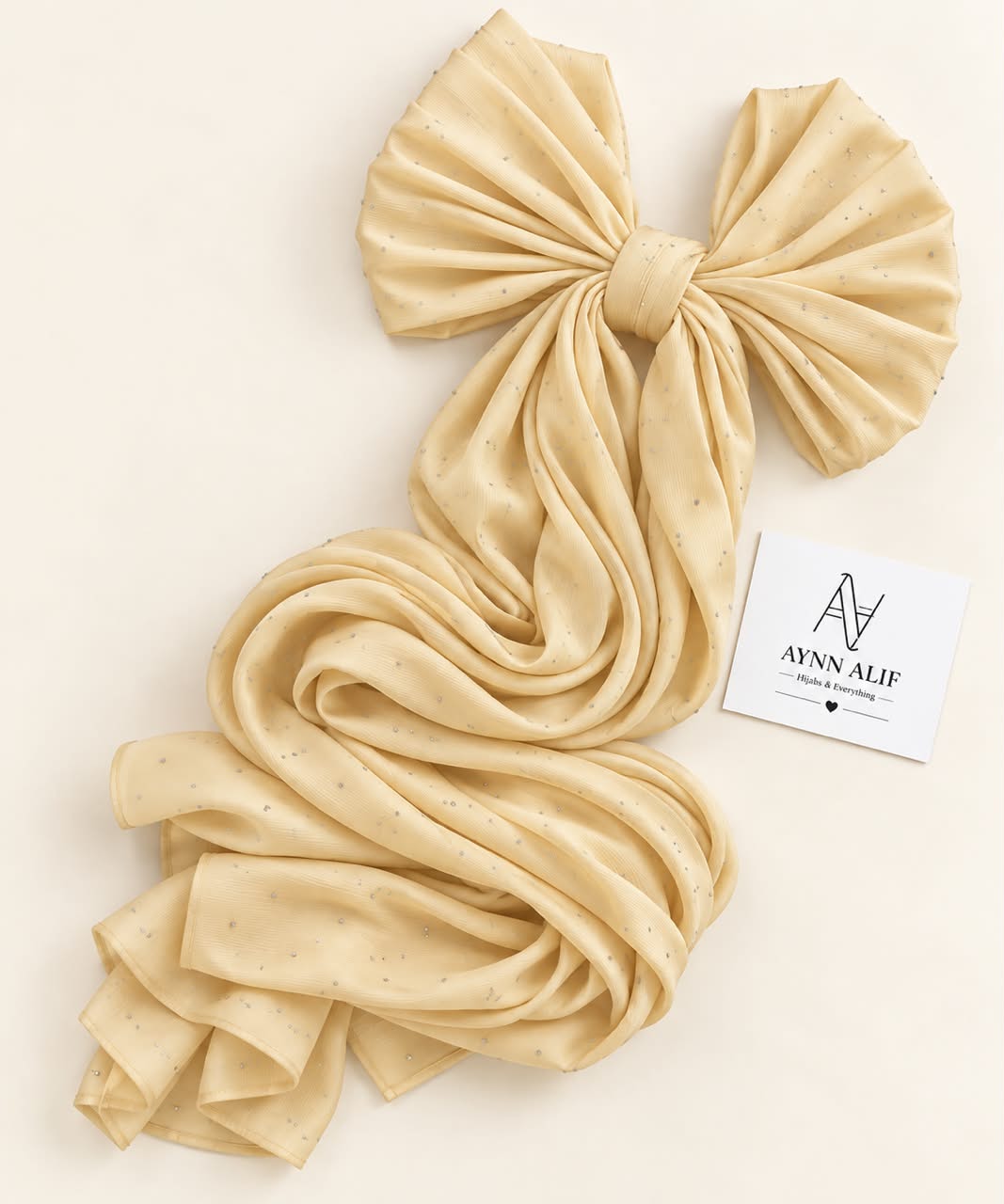 Gold stones-studded matte silk hijab with a soft, flowy drape and delicate stone embellishments by Aynn Alif.