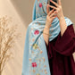 Ice blue cashmere embroidered hijab with pink and green floral details, delicate sequin embellishments, and matching fringed edges by Aynn Alif