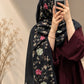 Jet black cashmere embroidered hijab featuring colourful floral motifs, delicate sequin embellishments, and matching black fringed edges by Aynn Alif.