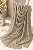 
Khaaki crinkle chiffon georgette hijab with satin stripes and delicate stone-studded detailing by Aynn Alif.