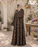 Leopard print front open double-flare abaya in a flowy silhouette, styled with a neutral hijab in a garden setting.