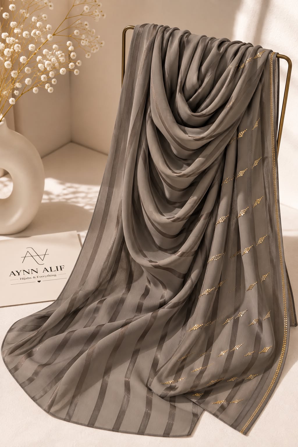 Light brown crinkle chiffon georgette hijab with satin stripes and delicate stone-studded detailing by Aynn Alif.