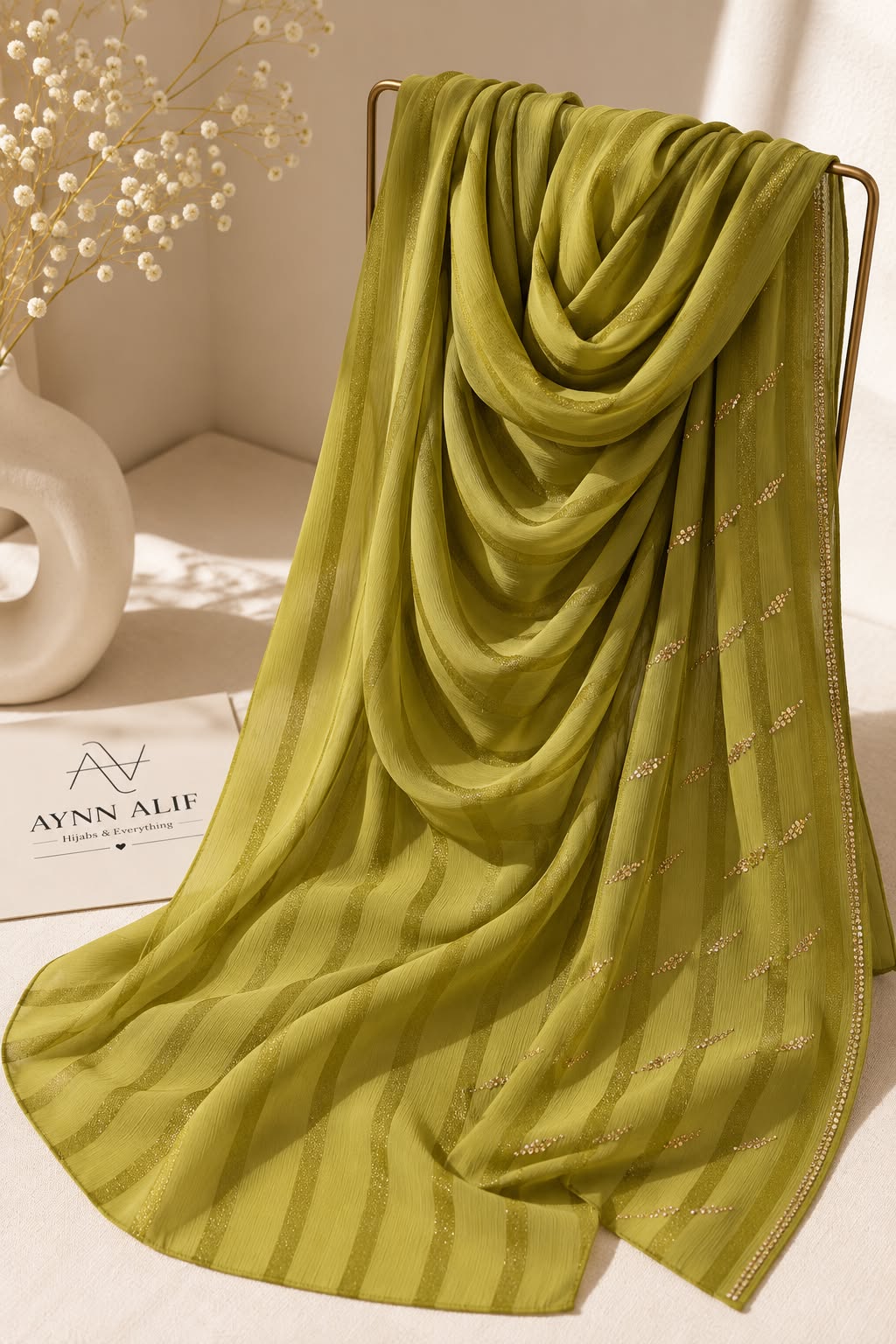 Lime green crinkle chiffon georgette hijab with satin stripes and delicate stone-studded detailing by Aynn Alif.