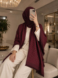 Maroon monogram-inspired pashmina wrap with tonal pattern, refined border and fringed edges styled as an elegant winter layer for women
