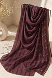 Maroon crinkle chiffon georgette hijab with satin stripes and delicate stone-studded detailing by Aynn Alif.