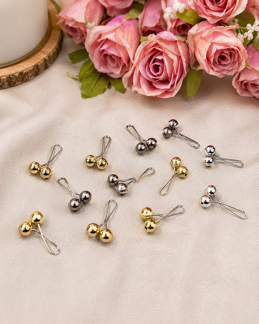 Metallic loop pin for hijab styling featuring polished gold and silver bead ends with smooth glider design, secure snag-free scarf accessory.