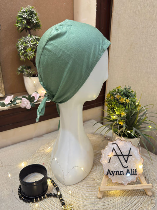 Mint green plain hijab cap on mannequin