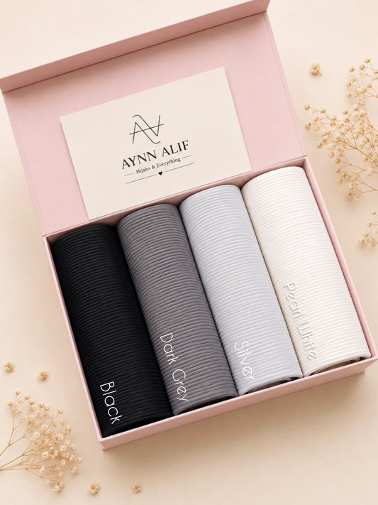 
Monochrome Luxe Ribbed Jersey Hijab Box featuring Black, Slate Grey, Pearl Grey and Ivory White premium anti-slip narrow ribbed jersey hijabs in a luxury gift box.
